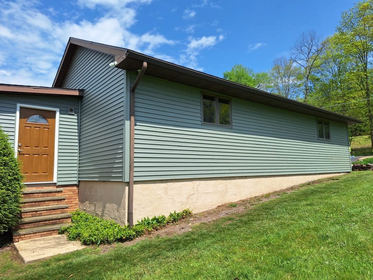 A side of a home with new vinyl siding.